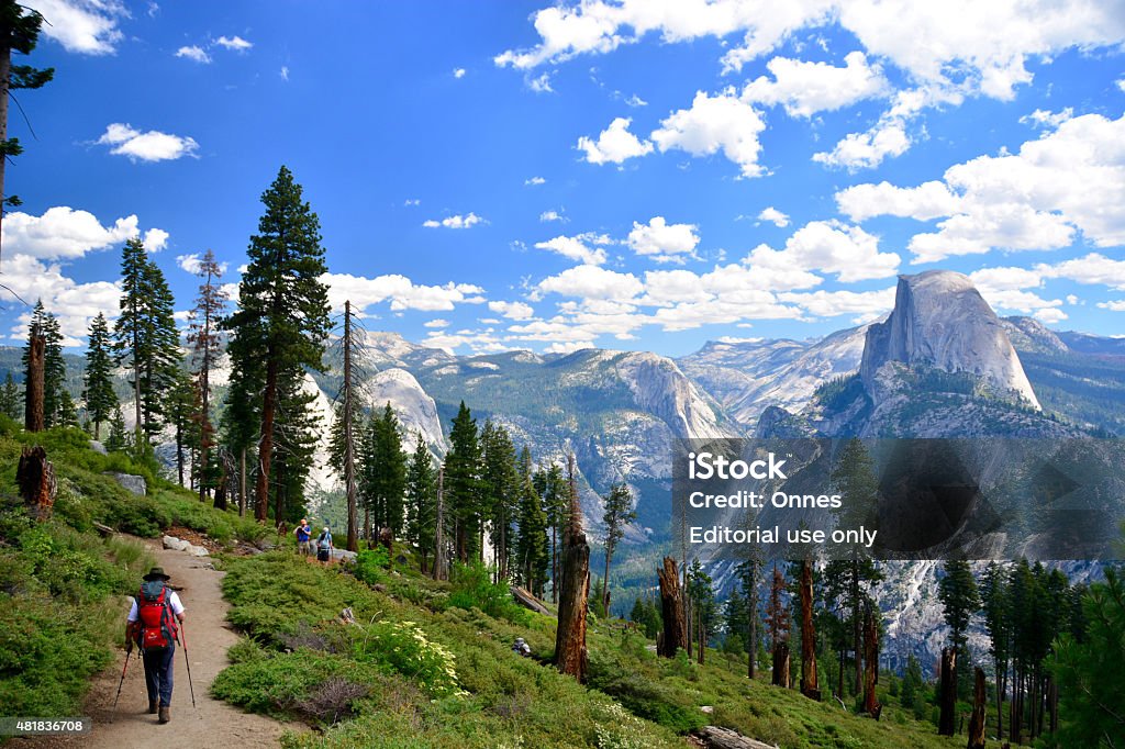 People hikers hiking in Yosemite National Park on sunny day Yosemite, USA - July 6, 2015: Yosemite National Park, Hikers hiking around and climbing half dome on a sunny day Yosemite National Park Stock Photo