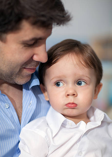 istock Pout Boy on Father's Knees 481837766