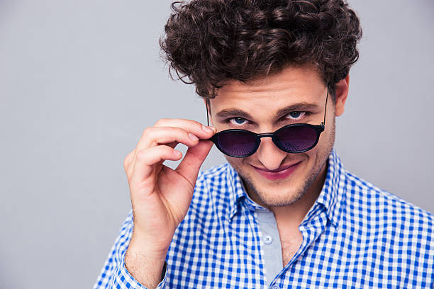 istock Man holding sunglasses and looking at camera 481842552