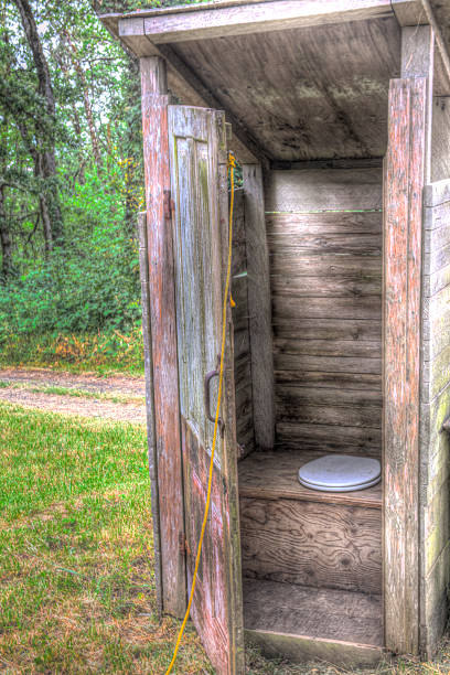 old wooden outhouse with open door old wood outhouse with open door and toilet seat outhouse interior stock pictures, royalty-free photos & images