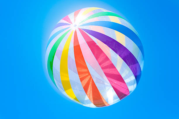 Colorful rubber ball against the blue sky.