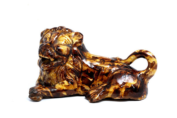 a small statue of lion made of ceremaic material