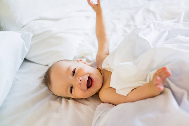 istock Joyful baby boy lying on a bed. 481851128