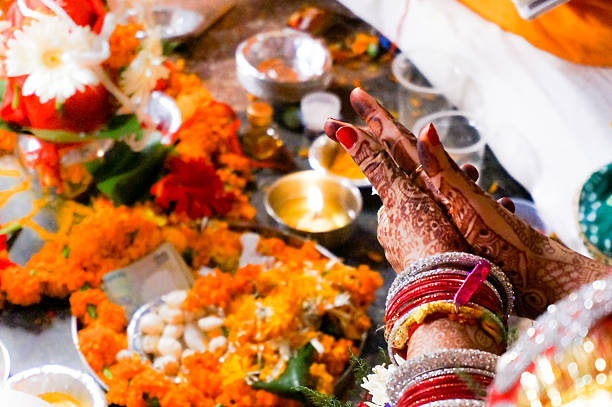 istock Indian bride hands praying to flame and flowers 481852020