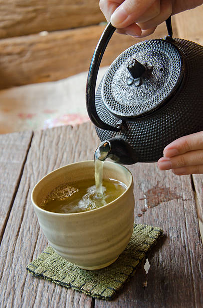 istock Pouring Japanese green tea 481852614