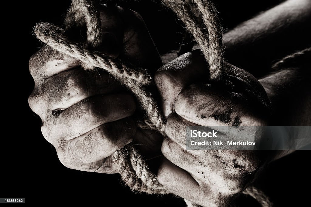 Concept of aggression Concept of aggression. Male hand with rope 2015 Stock Photo