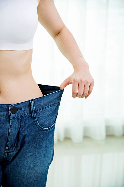 istock Young woman losing weight 481857928