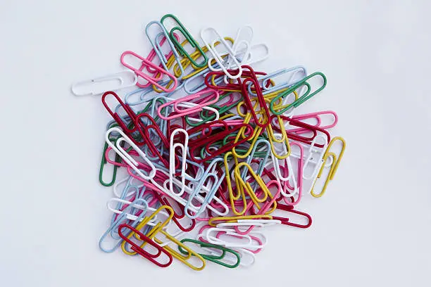 Bunch of colorful paper clips isolated on white background.