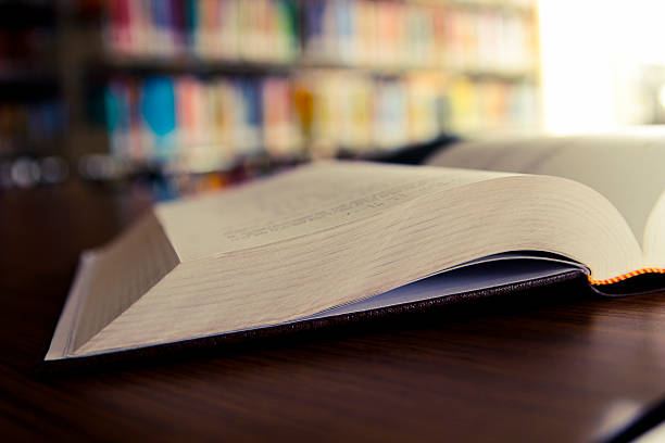 istock Close up of an open book at a library 481865850