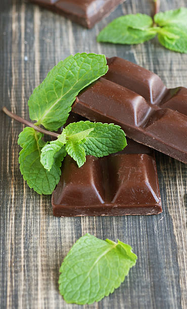 istock pieces of chocolate with mint lying on a wooden 481866276