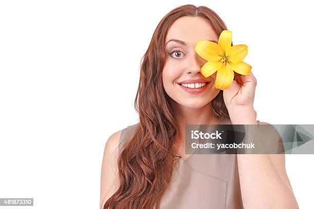 Pretty Redhaired Woman Holding Flower Near Face Stock Photo - Download Image Now - 2015, Adult, Beautiful People