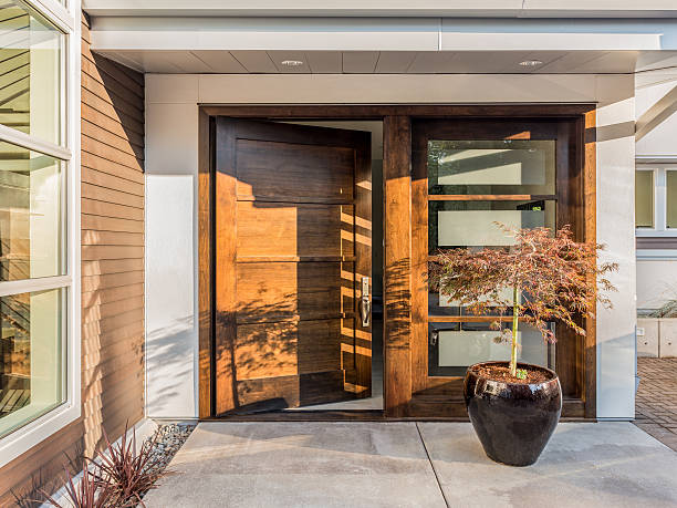 Beautiful Doorway To New Luxury Home Large and Wide Hardwood Door Slightly Ajar at Entrance to House doorway stock pictures, royalty-free photos & images
