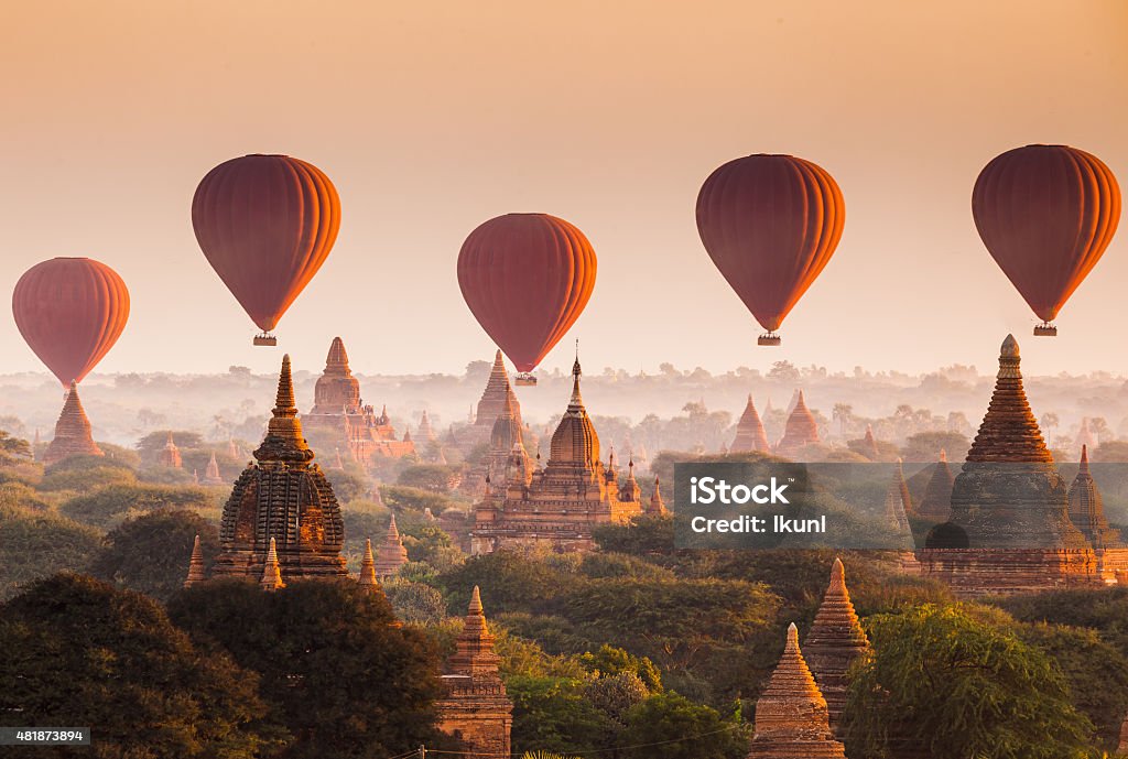 Balloon over plain of Bagan in misty morning, Myanmar Bagan is an archaeological zone of more than 2,000 ancient pagodas. It was built in 11th centuries during the rise of Bagan empire.Today Bagan is a part of Mandalay division, Myanmar. Myanmar Stock Photo