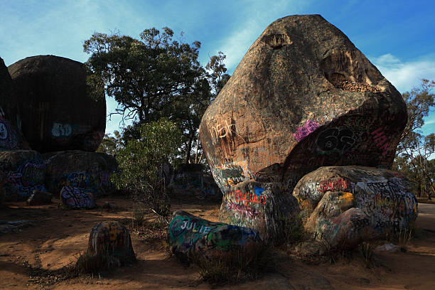 Roadside boulder vandalized with grafffiti.