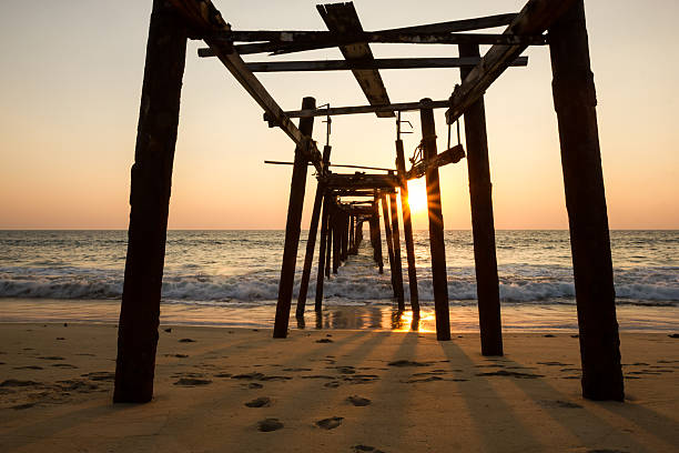istock Decaying wooden bridge in the sea with sunset 481875781