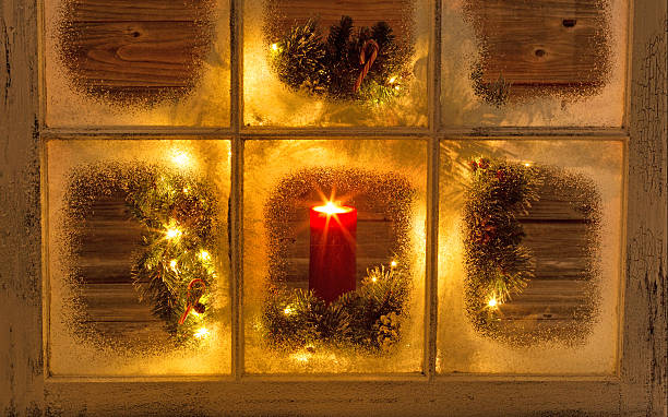 istock Glowing candle in holiday window 481878982