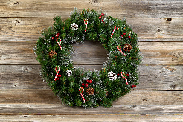 istock Christmas wreath with decorations on rustic wooden boards 481878990