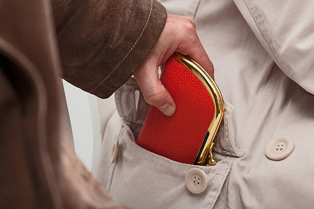 Pickpocket with wallet A closeup of a pickpocket stealing an expensive purse pickpocketing stock pictures, royalty-free photos & images