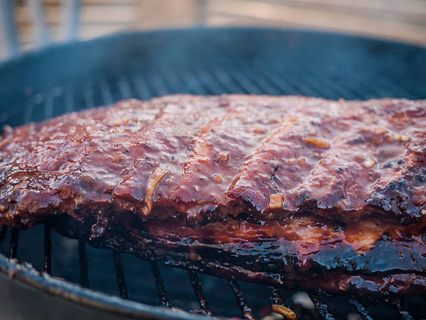 istock Ribs grill with fire side and smoke comming up 481880505
