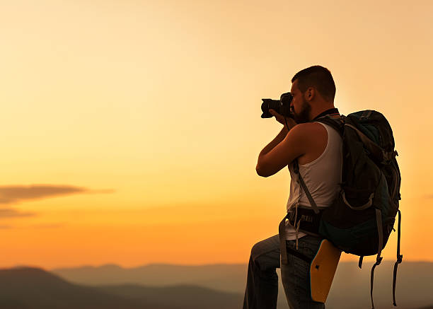 istock Nature photographer taking photos in the mountains 481880621
