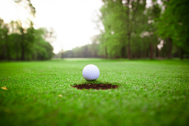 istock golf ball on lip of cup 481880723