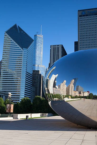 Cloud Gate sculpture in Millenium park CHICAGO,USA - JULY 12,2013: Cloud Gate sculpture in Millenium park in Chicago. This public sculpture is the centerpiece in Millennium Park within the Loop community area millennium park stock pictures, royalty-free photos & images