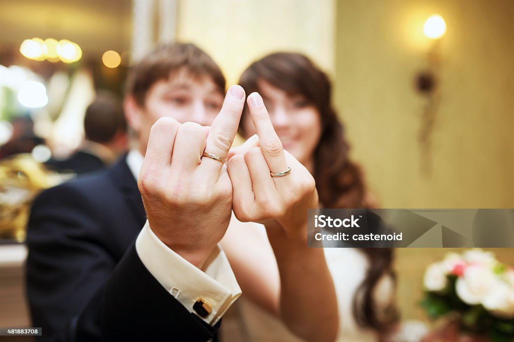 Bride and groom The bride and groom show wedding rings on fingers 2015 Stock Photo