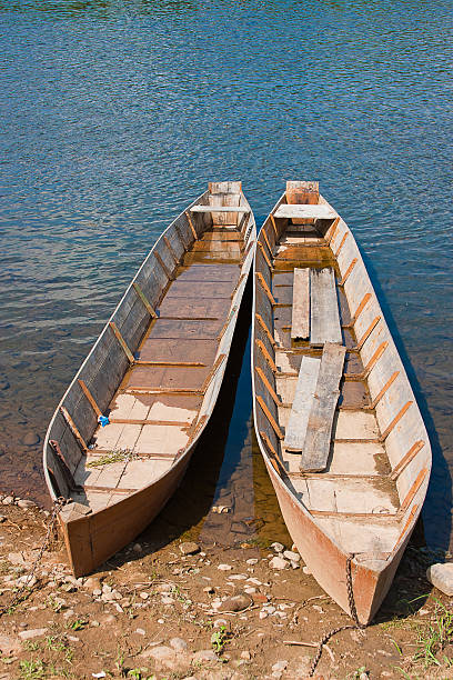 istock two wooden boats on the riverside 481885241