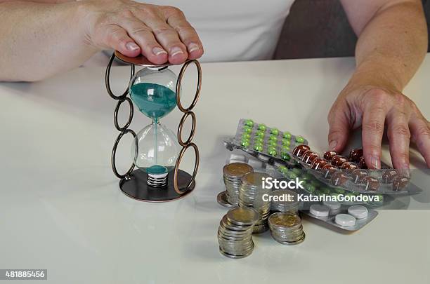 Pills Money And Hourglass Stock Photo - Download Image Now - 2015, Alarm Clock, Blister