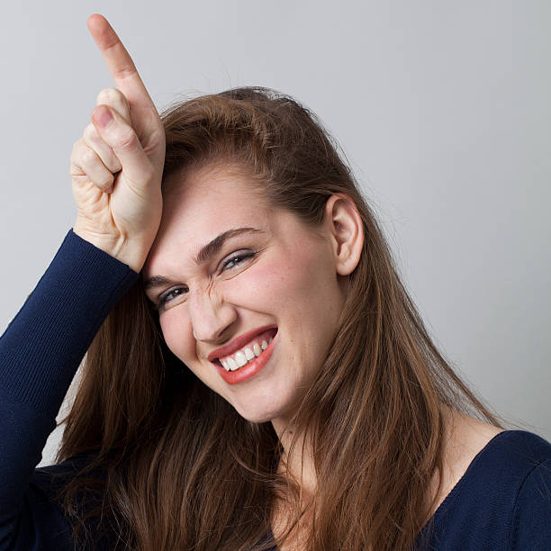 istock thrilled 20s girl pointing her finger on forehead for fun 481885940