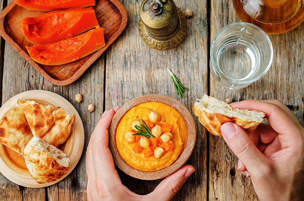istock Man holding pumpkin rosemary hummus 481886956
