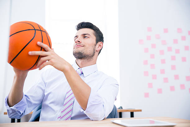 istock Businessman sitting at the table with ball 481887290