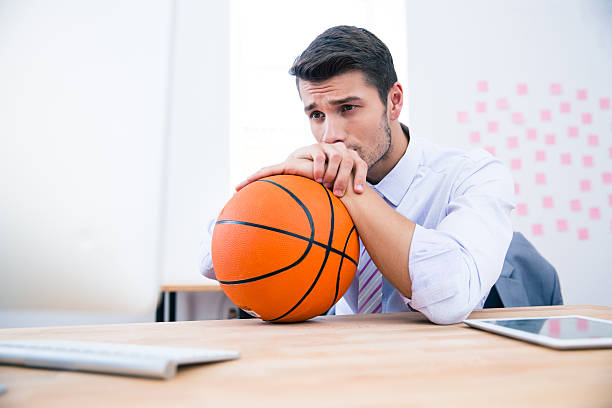 istock Pensive businessman sitting at the table with ball 481887316
