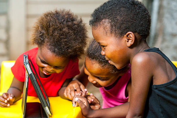 istock Threesome african kids having fun with tablet. 481889483