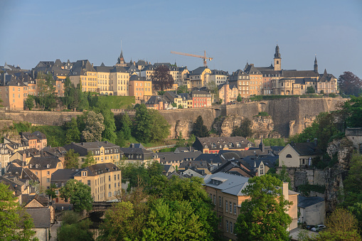 Picture of Luxembourg's Old City skyline at sunrise, during springtime, depicting the old suburb of Grund with its old medieval houses.