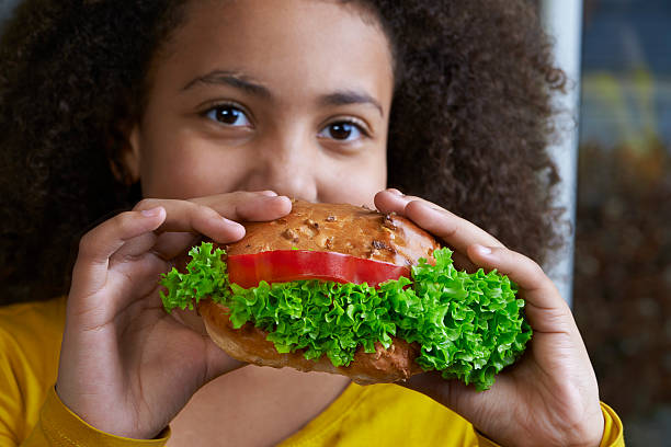 istock Girl eating a sandwich 481895543