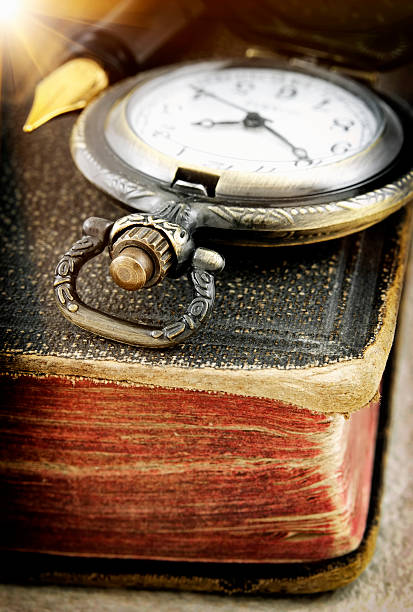Old book and pocket watch (macro photo)