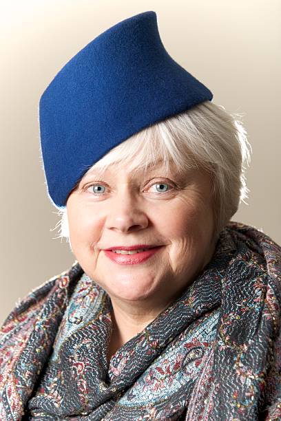 istock White-haired woman in blue hat and shawl 481896057