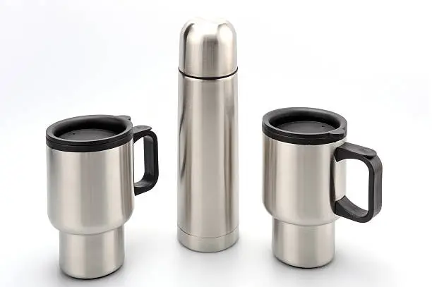 Image of a stainless steel insulated bottle with two thermos mugs against a white background.