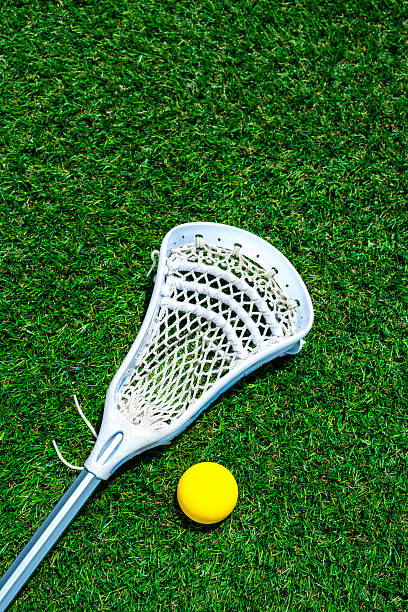 istock Lacrosse stick and yellow ball on artificial turf 481896270