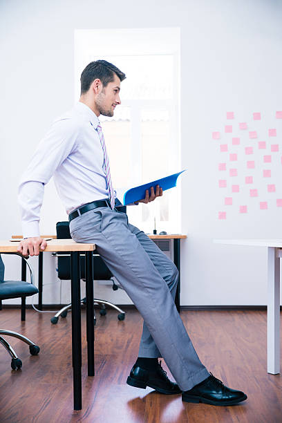 istock Pensive businessman leaning on the table with folder 481900264