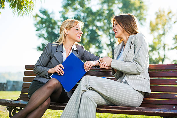 istock Business women laughing in park. 481900833