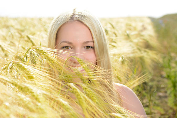istock Beautiful young blonde woman sitting in corn field 481903780