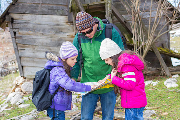 istock Family in nature looking at map 481903855