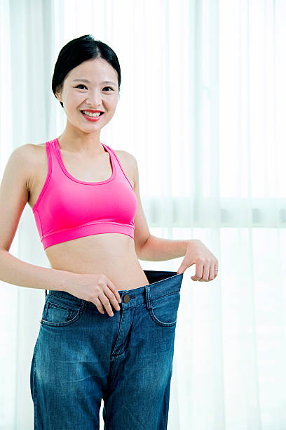 istock Young woman losing weight 481905932
