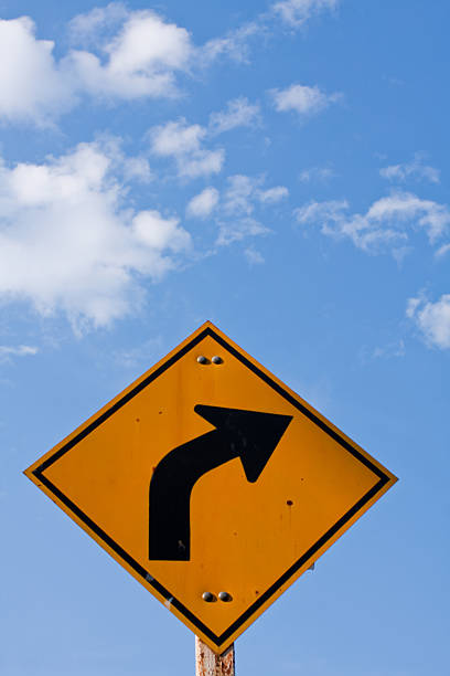 Direction sign- right turn warning on blue sky stock photo