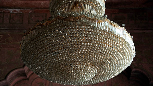 Delhi, India. InsideThe Jama Masjid, the principal mosque of Old Delhi.  Chandelier as decorative ceiling-mounted light fixture. Ornated, using dozens of lamps and complex arrays of glass or crystal.