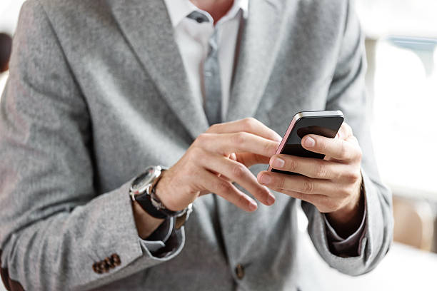 istock Businessman wearing grey suit using smart phone 481907922