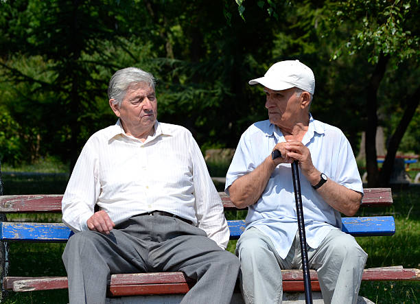 istock Two old gentleman resting on a park bench 481907994