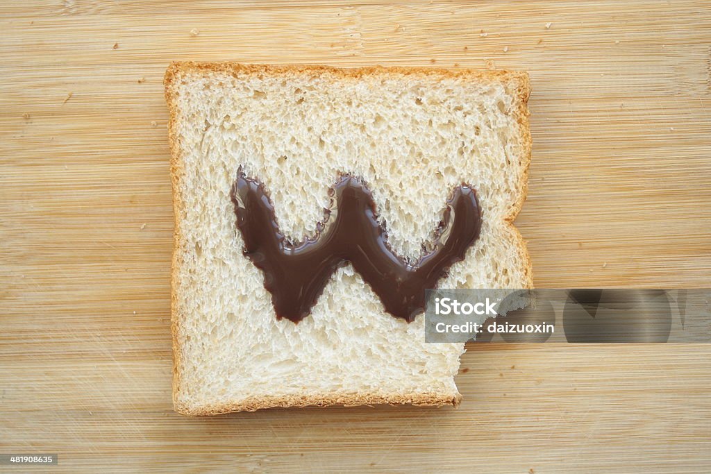 Alphabet drawn on slice of bread Alphabet Stock Photo
